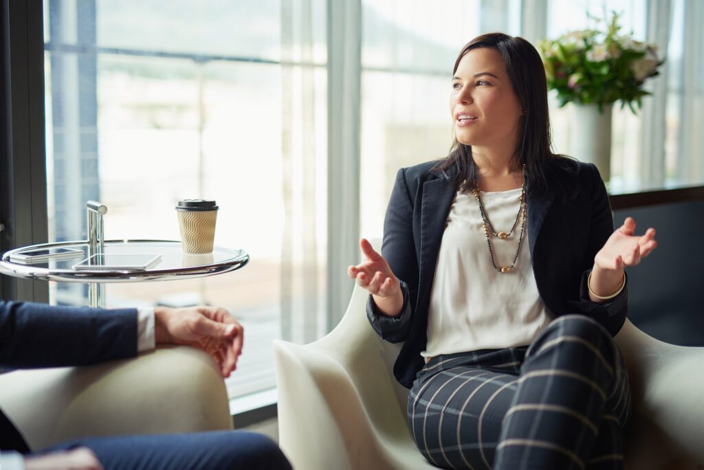 Running an idea by a colleague. Shot of two businesspeople talking in a corporate office.